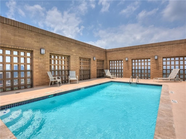 view of swimming pool featuring a patio area