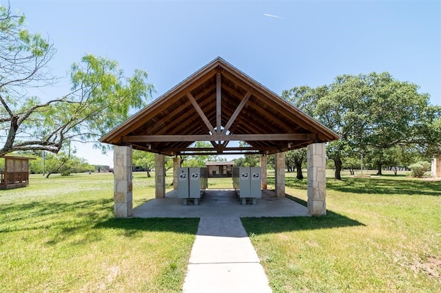 view of property's community with mail boxes and a yard