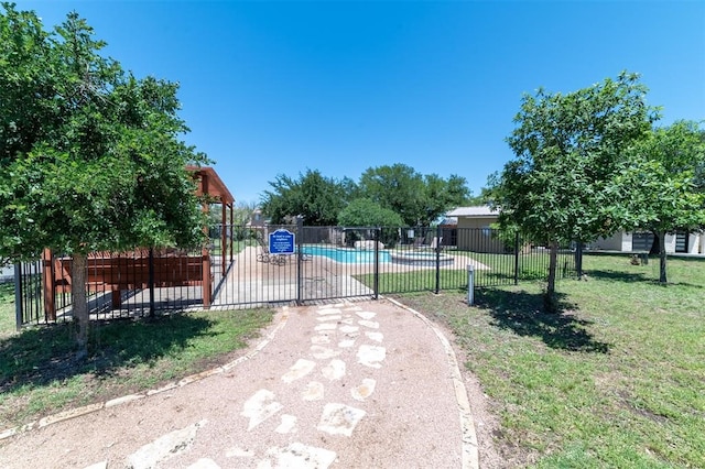 exterior space featuring a yard and a community pool