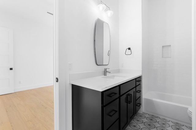 full bathroom featuring vanity, wood-type flooring,  shower combination, and toilet