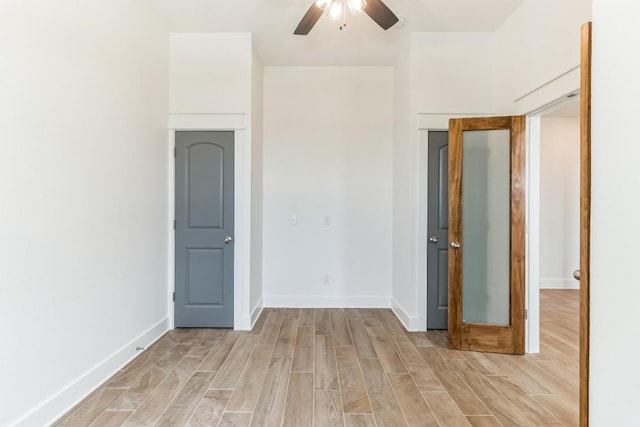 empty room featuring ceiling fan and light hardwood / wood-style floors