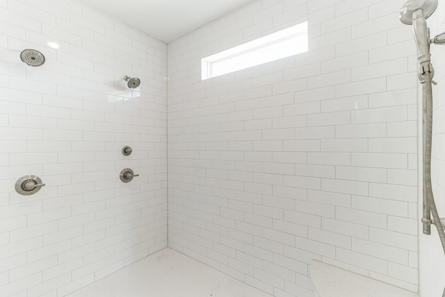 bathroom with a tile shower