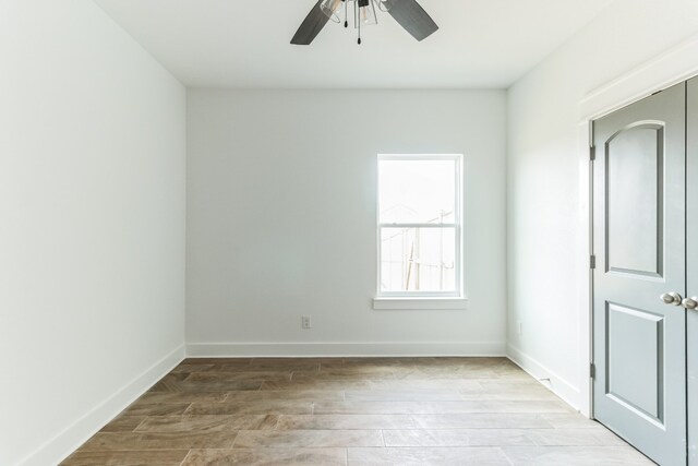 empty room with light hardwood / wood-style floors and ceiling fan