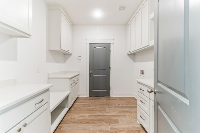 interior space featuring cabinets and hookup for a washing machine