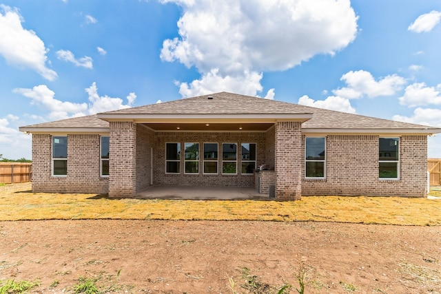 rear view of property featuring a patio area