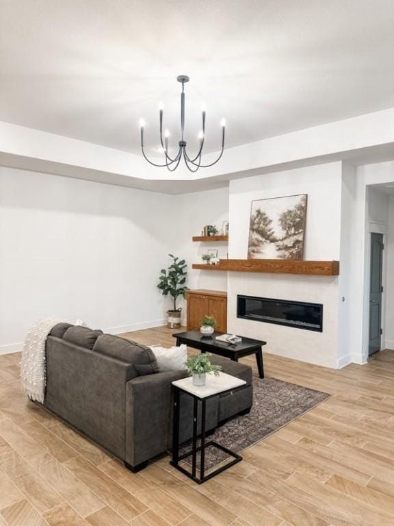 living room featuring light wood-type flooring and an inviting chandelier