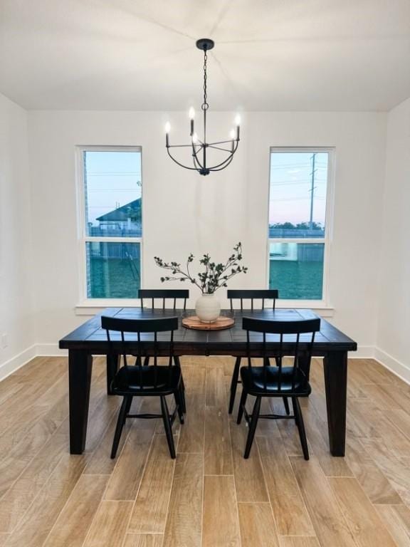 dining area featuring a notable chandelier and light hardwood / wood-style flooring