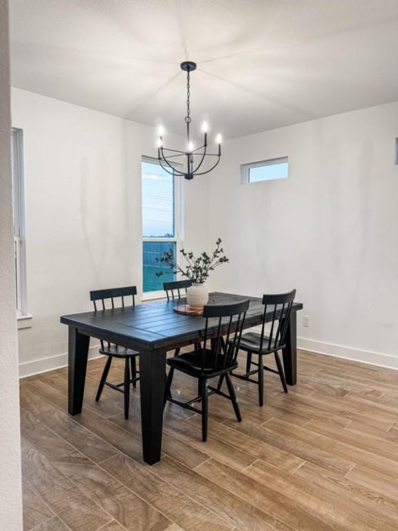 dining space featuring a notable chandelier and wood-type flooring