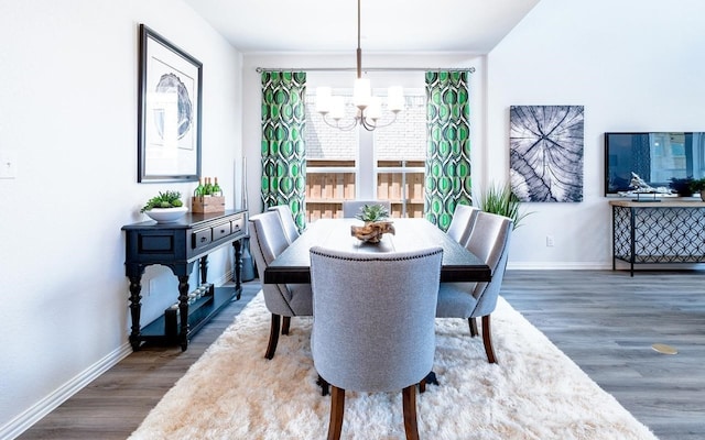 dining room featuring a notable chandelier and dark hardwood / wood-style floors