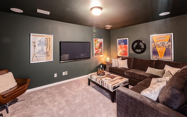 home theater with a textured ceiling and light carpet