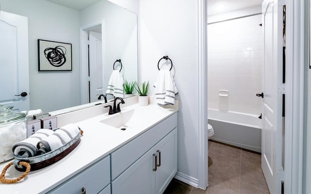 full bathroom featuring tile floors, toilet, double vanity, and shower / bath combination