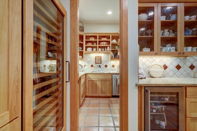 bar with backsplash, light tile floors, and beverage cooler