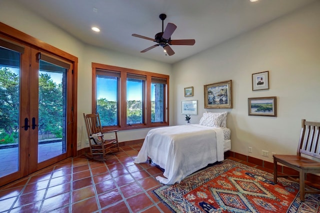 bedroom with dark tile flooring, french doors, access to exterior, and ceiling fan