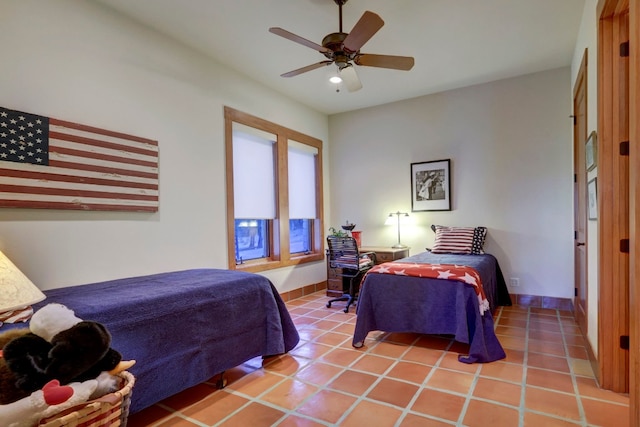 tiled bedroom featuring ceiling fan