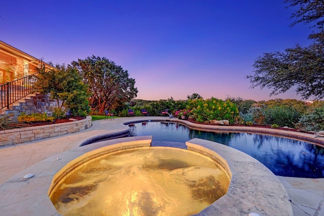 view of pool at dusk