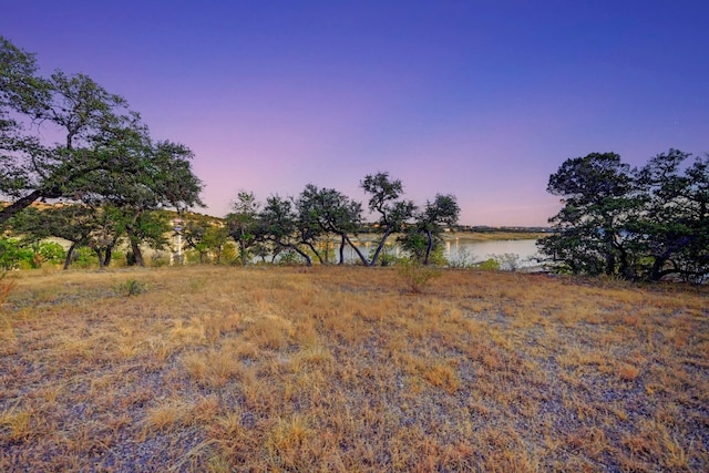 yard at dusk with a water view