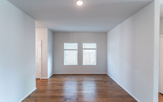 spare room with dark wood-type flooring