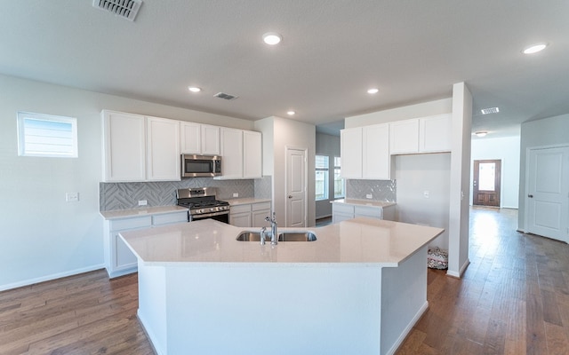 kitchen with white cabinetry, a center island with sink, stainless steel appliances, and sink