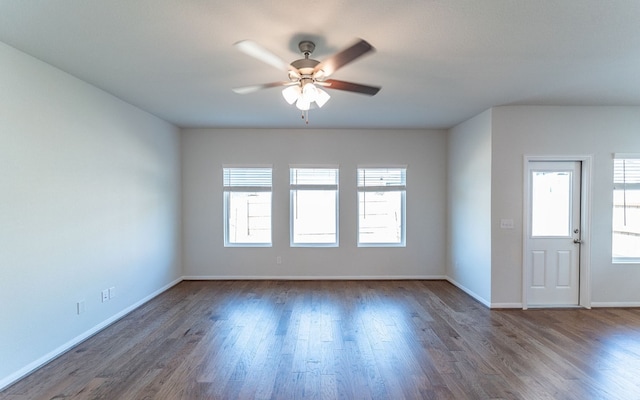 spare room with ceiling fan and dark hardwood / wood-style floors