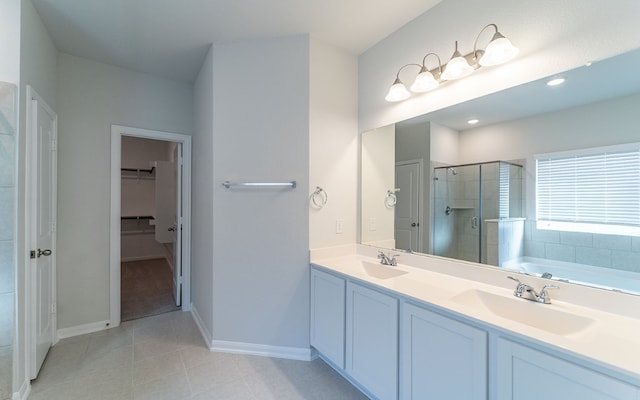 bathroom with tile flooring, dual sinks, plus walk in shower, and large vanity