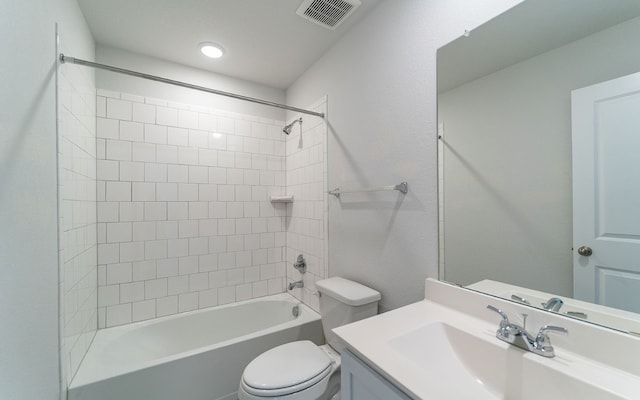 full bathroom with vanity with extensive cabinet space, toilet, and tiled shower / bath