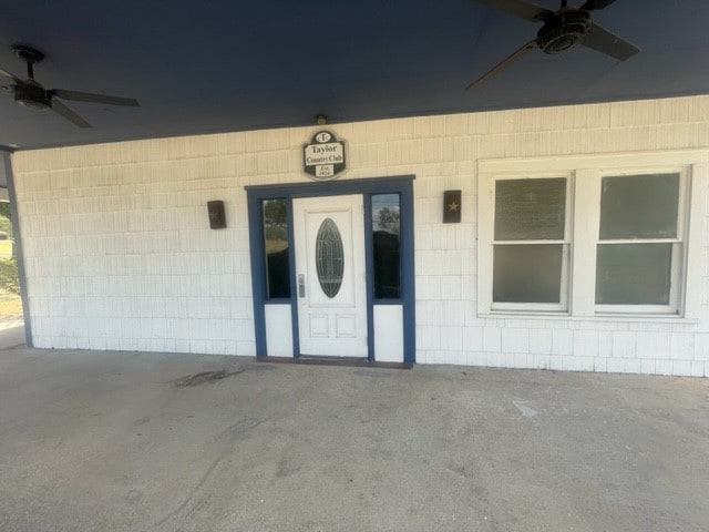 property entrance with a patio and ceiling fan