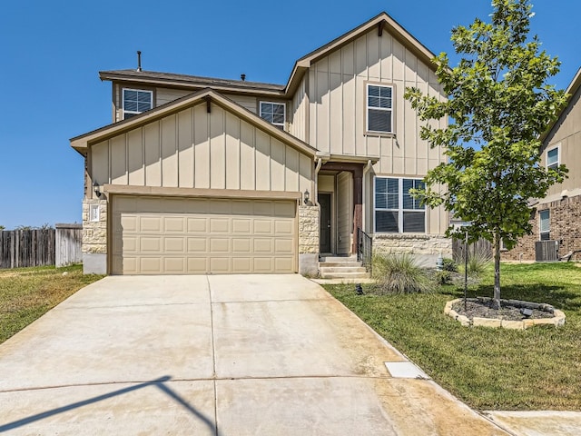 view of front of home featuring central air condition unit, a front lawn, and a garage