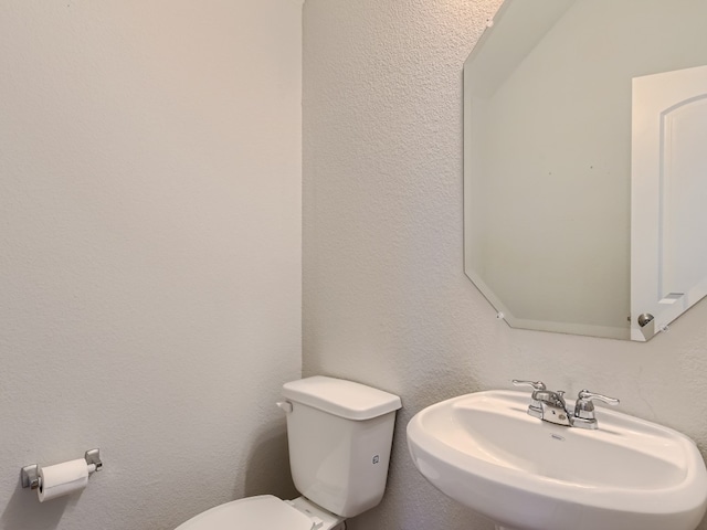 bathroom featuring toilet and sink