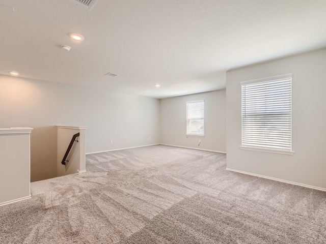 unfurnished room featuring light colored carpet