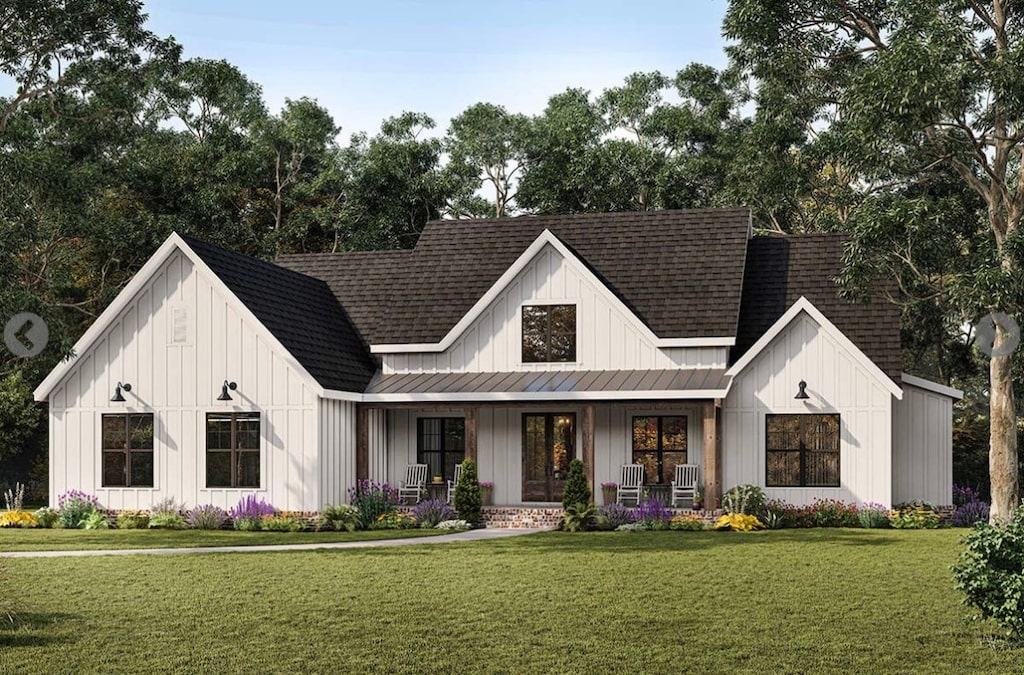 modern farmhouse style home with covered porch and a front lawn