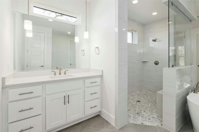 bathroom featuring tile patterned floors, plus walk in shower, and vanity