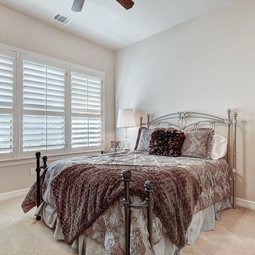 carpeted bedroom with ceiling fan