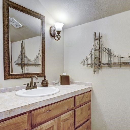 bathroom featuring a textured ceiling and vanity