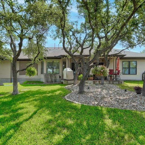 rear view of property featuring a yard