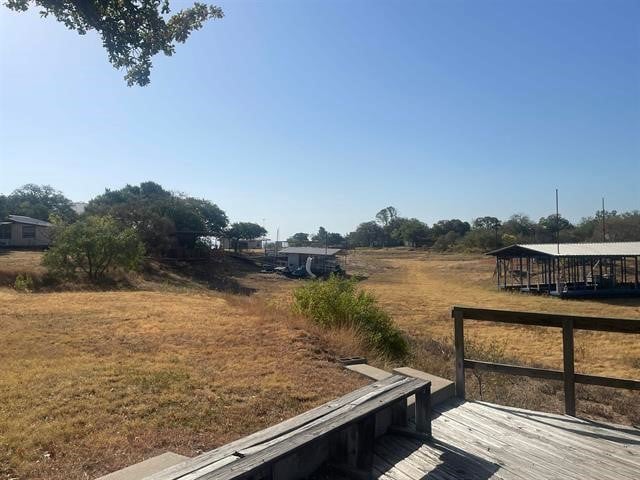 view of yard with a rural view and a deck