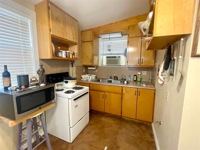 kitchen featuring backsplash, sink, and electric range