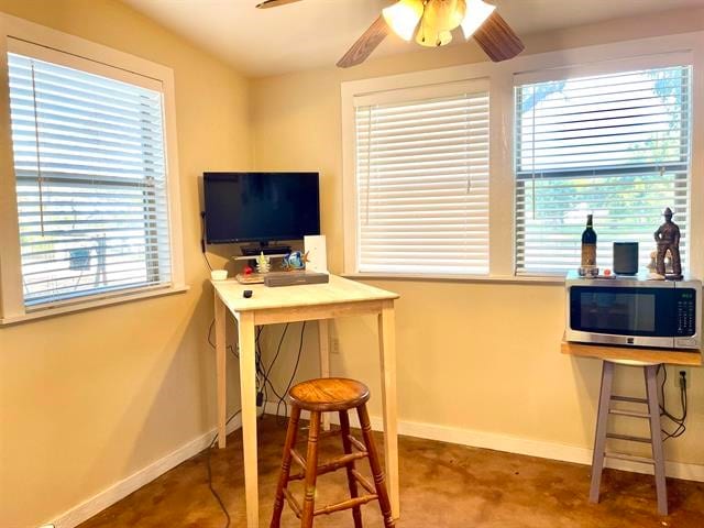 office area with plenty of natural light and ceiling fan