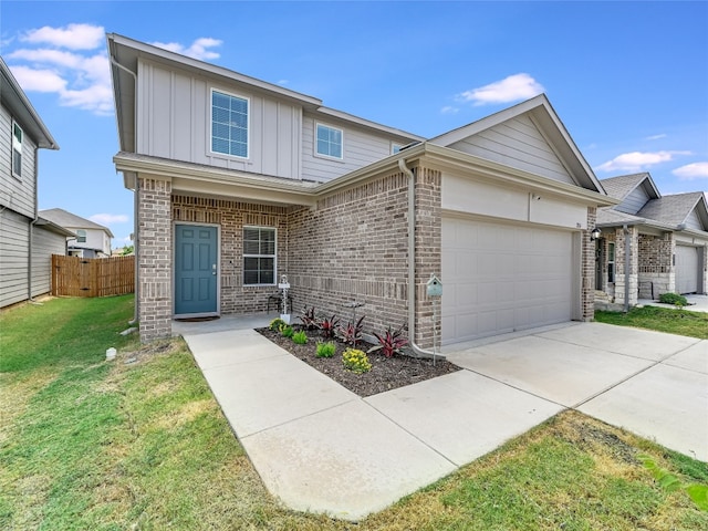 view of front of home with a front yard and a garage