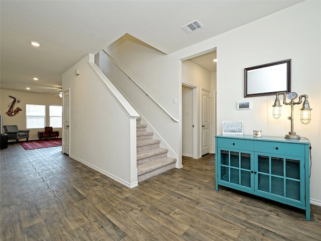 interior space with dark wood-type flooring and ceiling fan