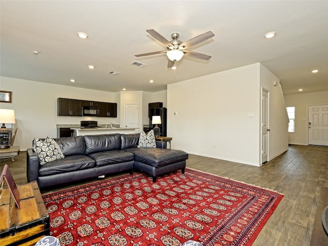 living room with ceiling fan and wood-type flooring