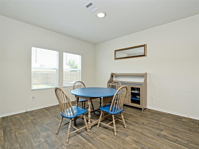 dining area with dark hardwood / wood-style flooring