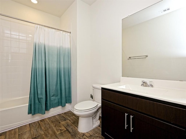 full bathroom featuring vanity, hardwood / wood-style flooring, toilet, and shower / bath combo