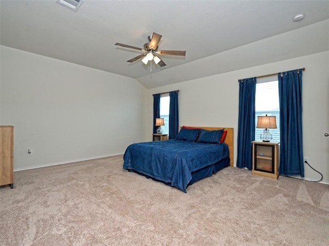 carpeted bedroom with ceiling fan and vaulted ceiling