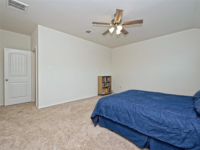 carpeted bedroom featuring lofted ceiling and ceiling fan