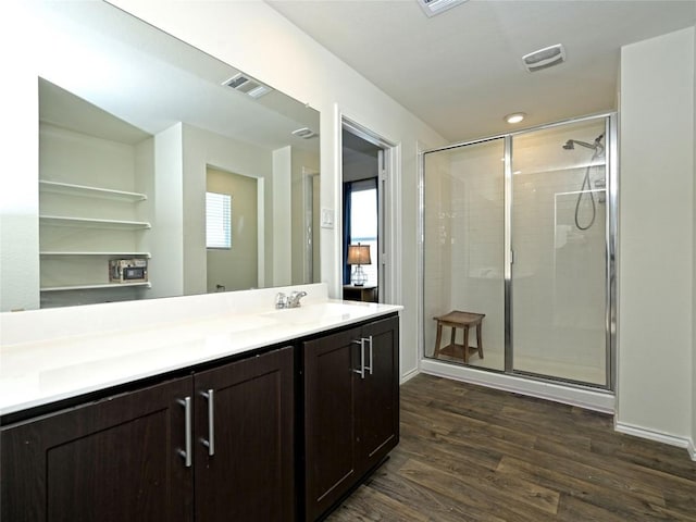 bathroom with vanity, hardwood / wood-style flooring, and a shower with shower door