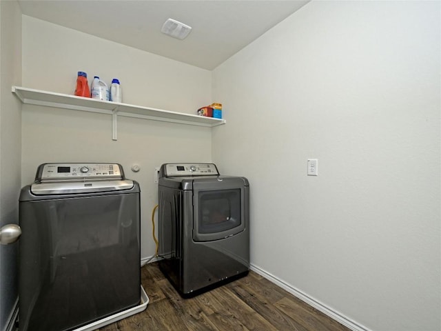 laundry room with dark hardwood / wood-style floors and washer and dryer