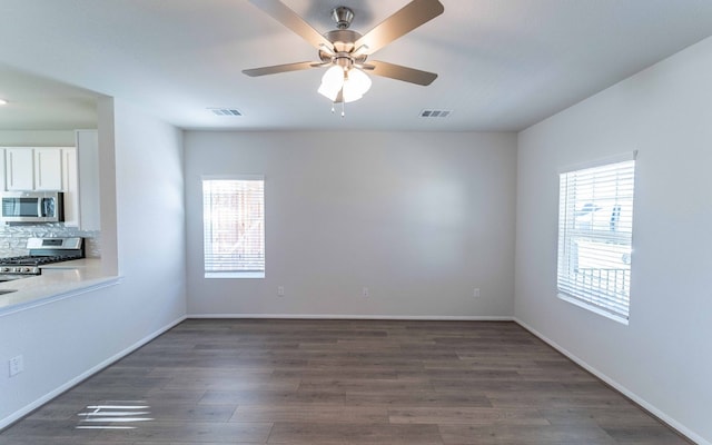 empty room with ceiling fan and hardwood / wood-style floors