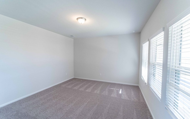 carpeted empty room with plenty of natural light