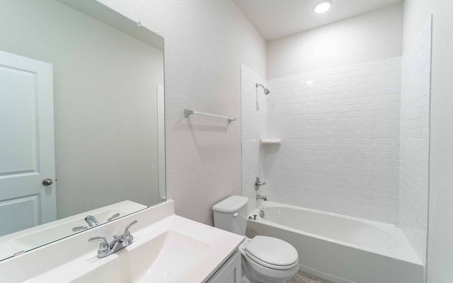 full bathroom with vanity, tiled shower / bath combo, and toilet