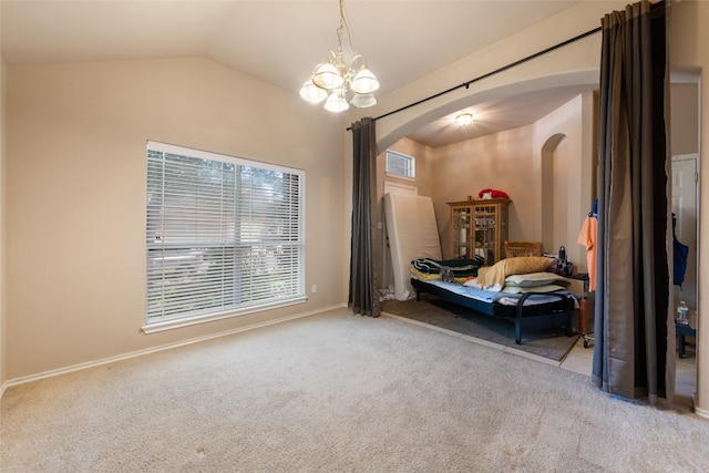 carpeted bedroom featuring vaulted ceiling and a notable chandelier